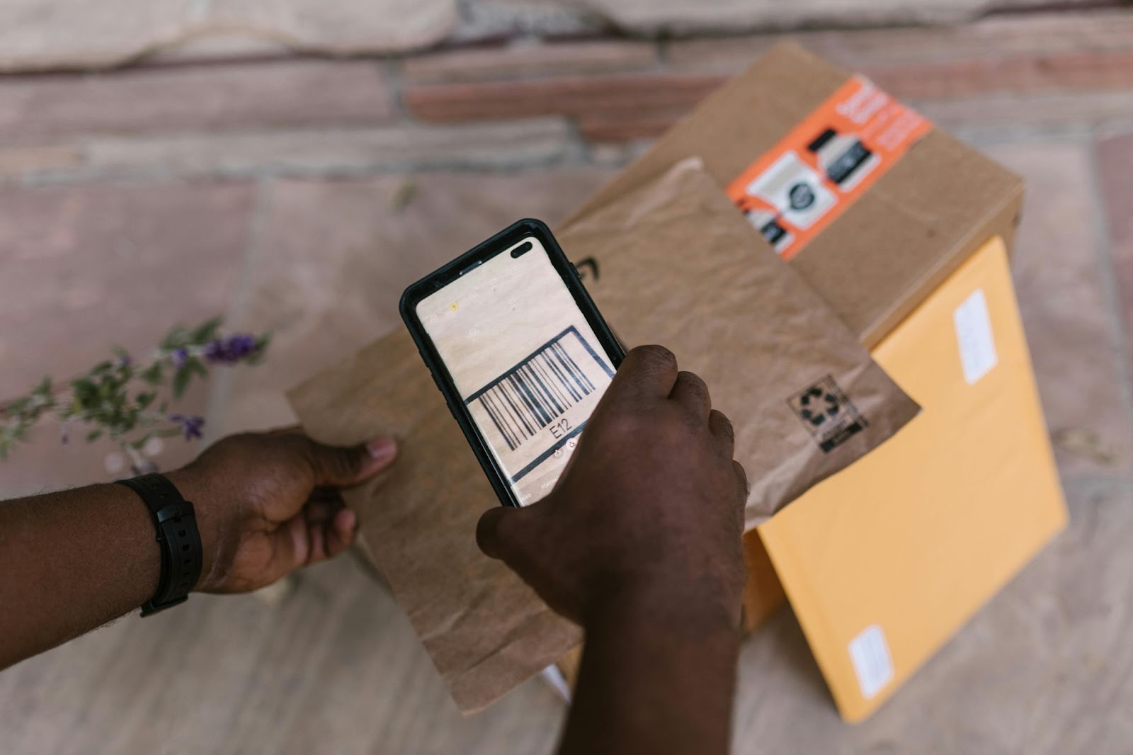 A delivery man scans the barcodes for delivered packages – Trackonomy