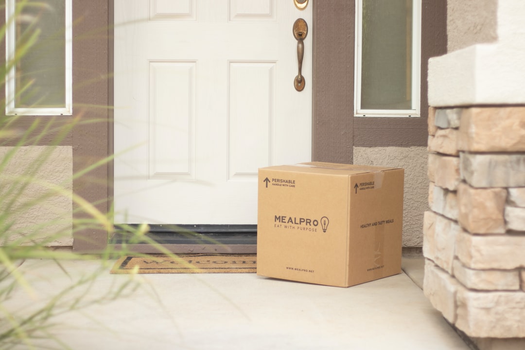A package sitting on a front door step.