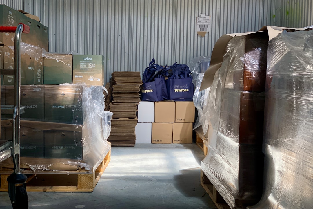 A warehouse filled with stacks of plastic-wrapped cardboard boxes.