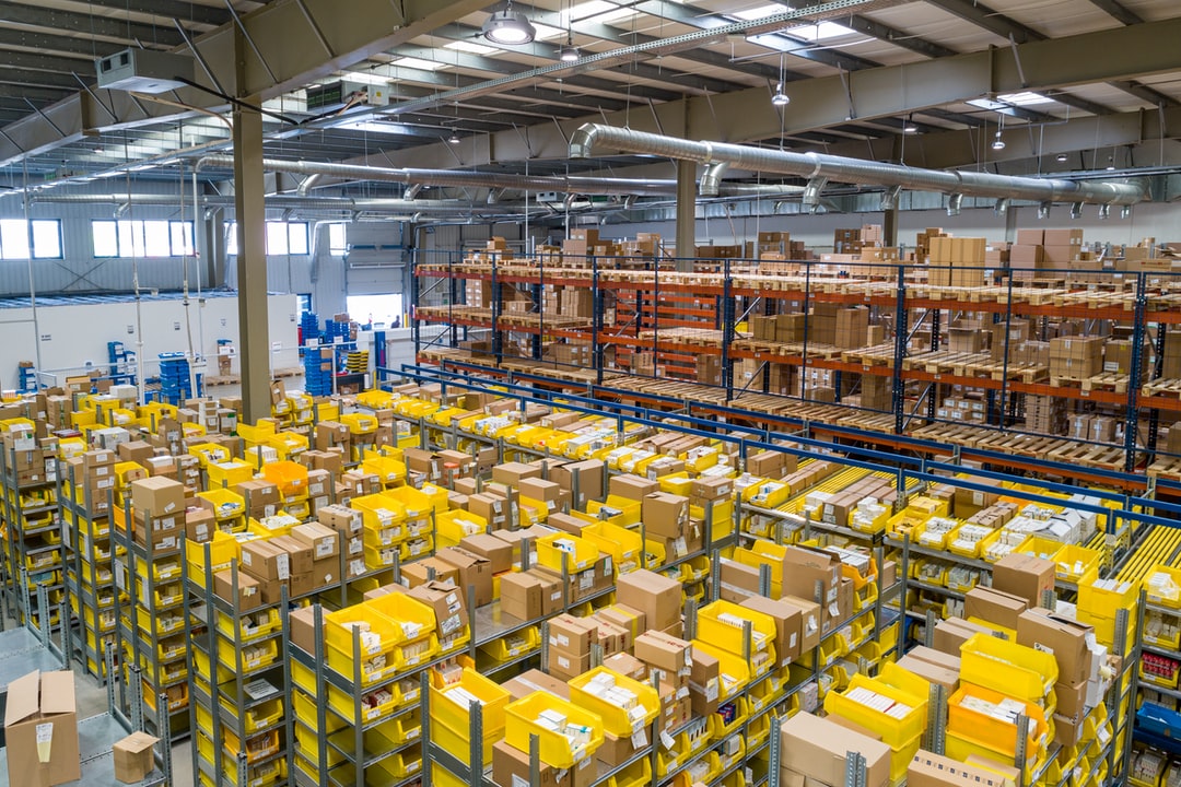 A large warehouse filled with shelves of cardboard boxes and packages.